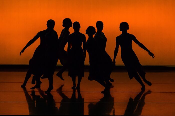 Silhouette of dancers with orange background